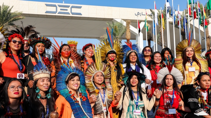 Attendees from Brazil wearing colourful clothing pose during the UN Climate Change Conference.