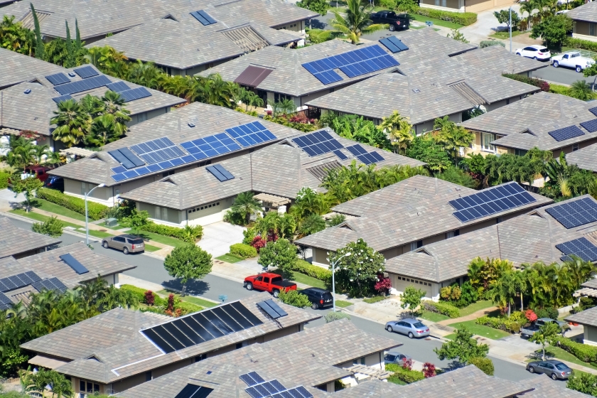 Houses with solar panels on their roofs. 