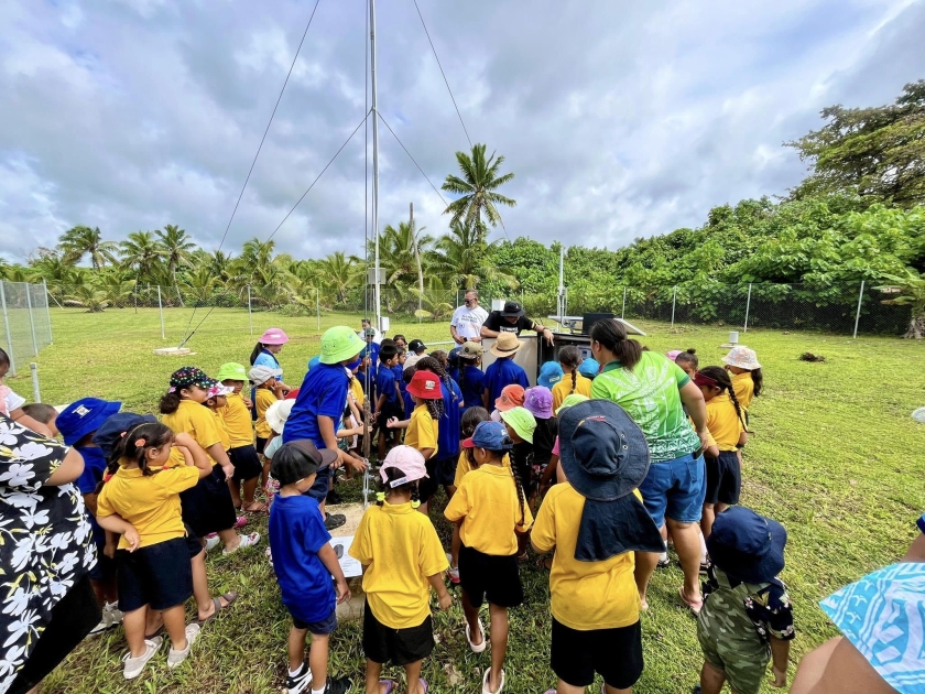 Children gather around some equipment